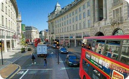 Buses and traffic moving through a monitored city street
